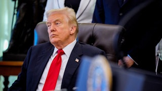 Trump leans back in chair, looking tired
