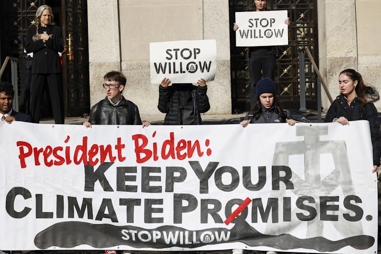 Demonstrators hold signs reading "Stop Willow" and "President Biden: Keep Your Climate Promises."