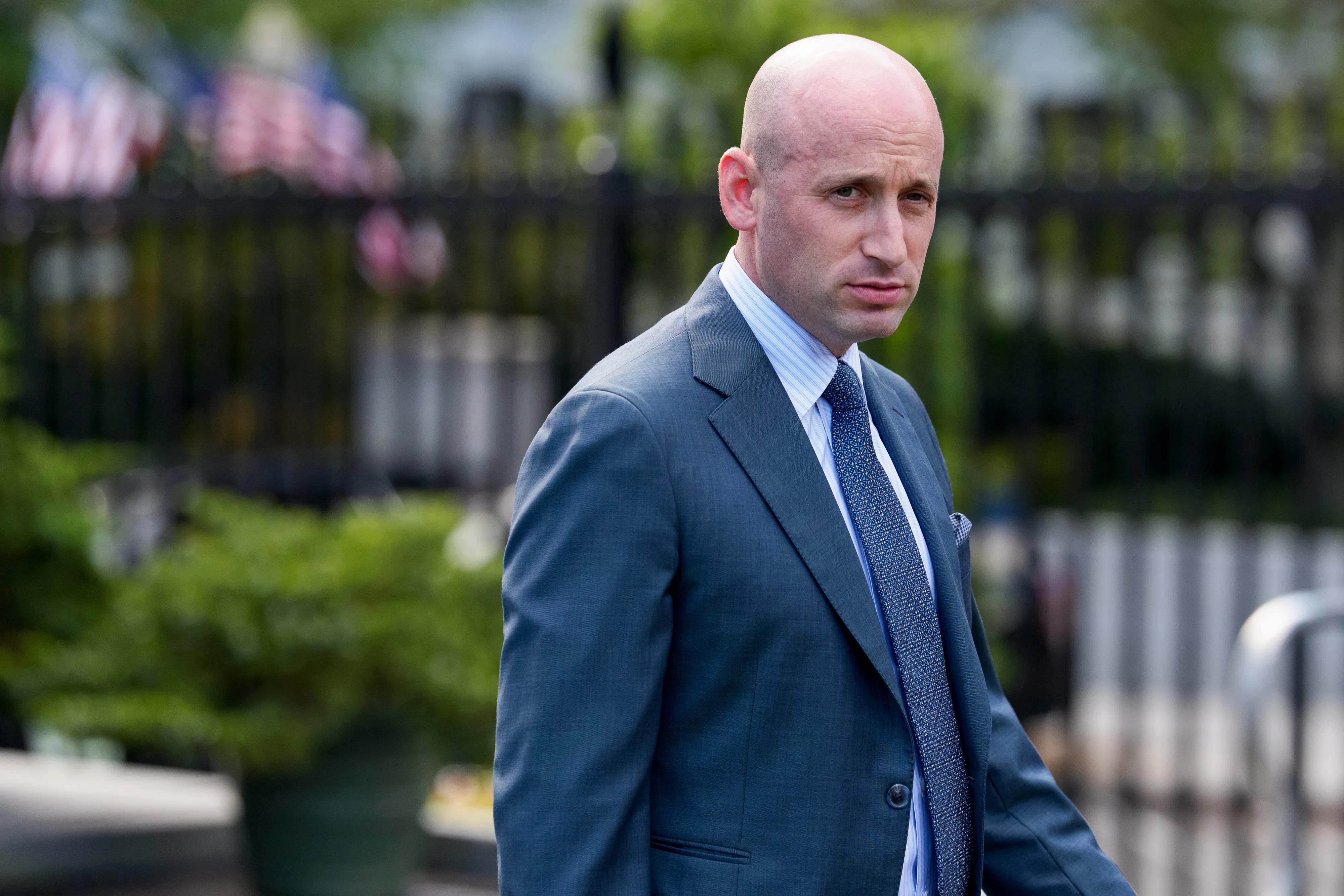 Stephen Miller glowers while walking