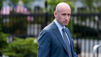Stephen Miller glowers while walking