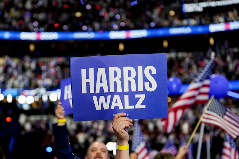 Someone holds up a Kamala Harris/Tim Walz sign at the Democratic National Convention