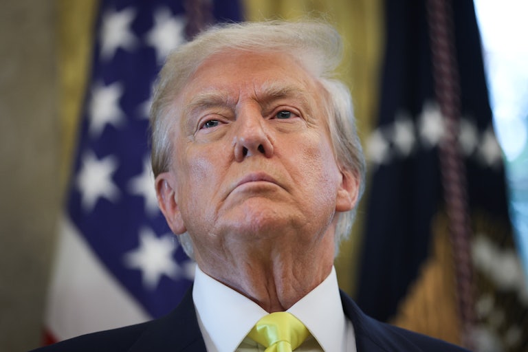 Donald Trump stands in the Oval Office