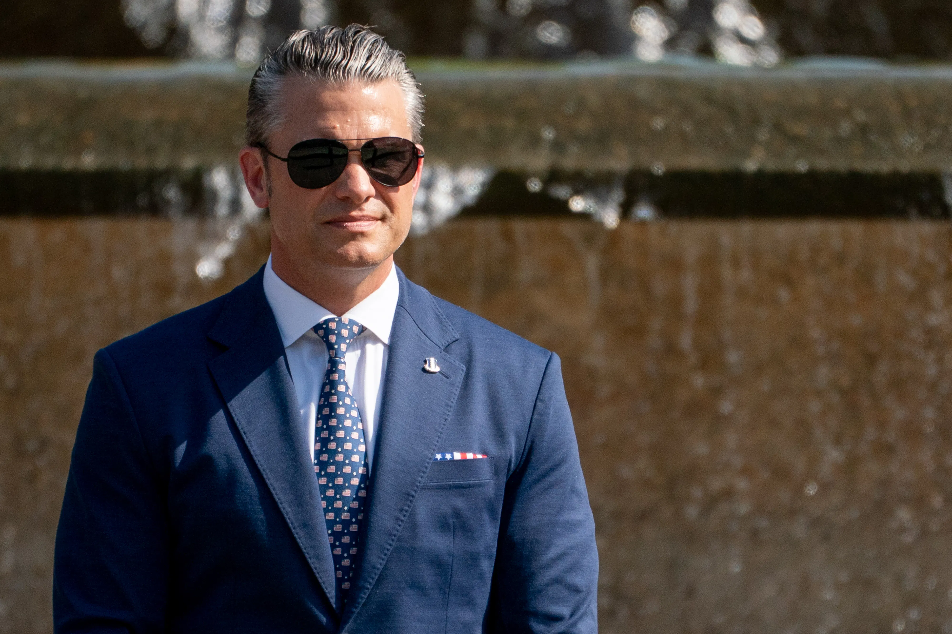 Defense Secretary Pete Hegseth stands in Malcolm X Park during a press conference