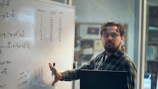 Leonardo DiCaprio stands at a whiteboard.