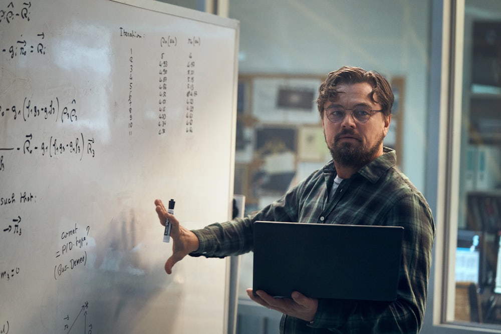 Leonardo DiCaprio stands at a whiteboard.