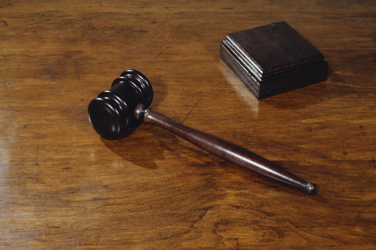 a gavel on a wood table
