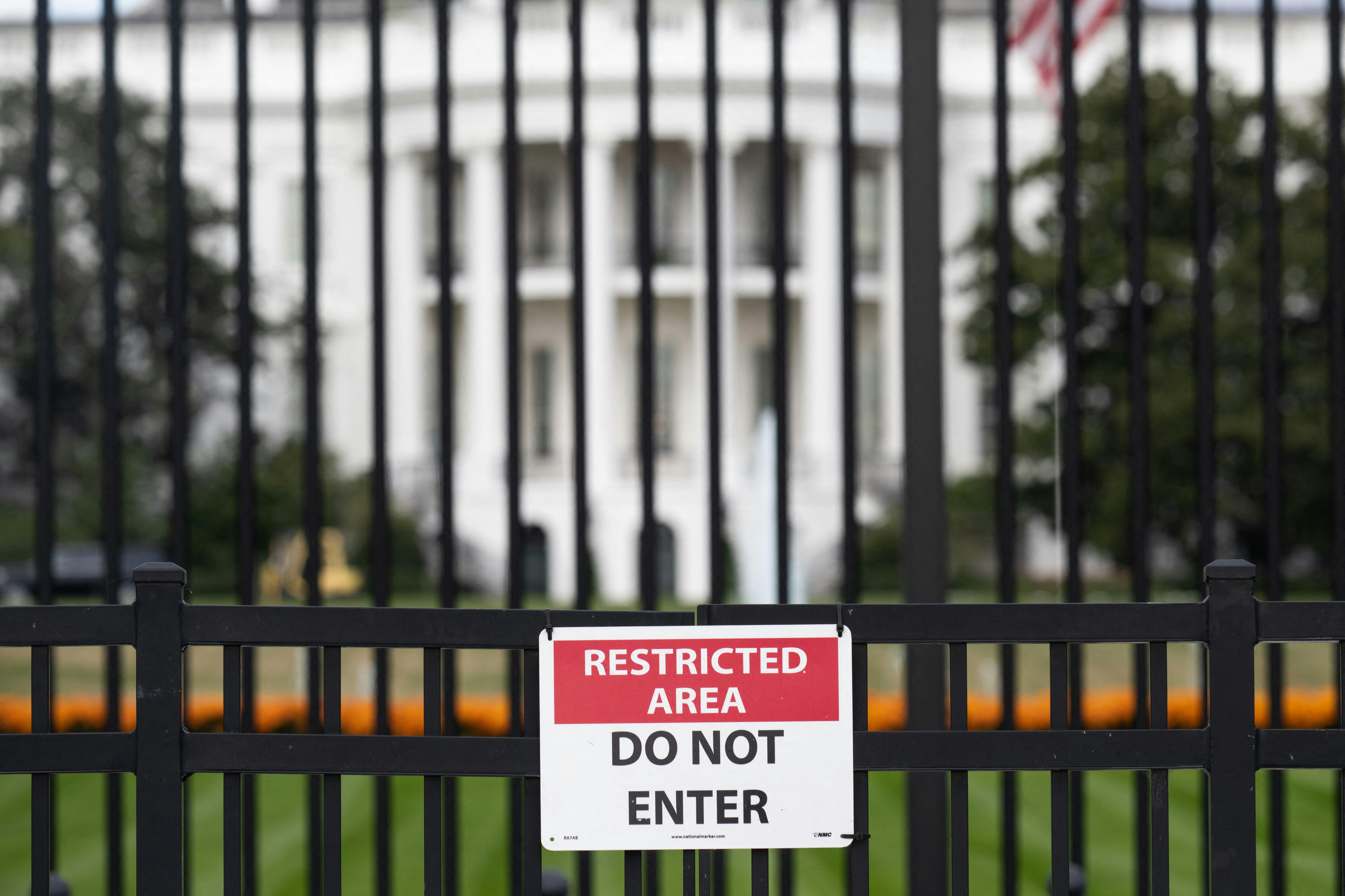 A sign is attached to the exterior fence at the South Lawn of the White House as demolition work is underway on the East Wing to begin construction on President Donald Trump’s planned ballroom.