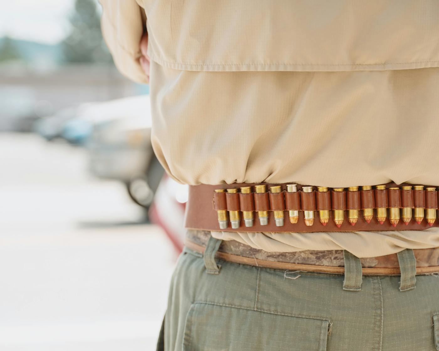 A concerned citizen wears a gun belt with spare ammunition during the No Kings rally in Libby Montana on June 14