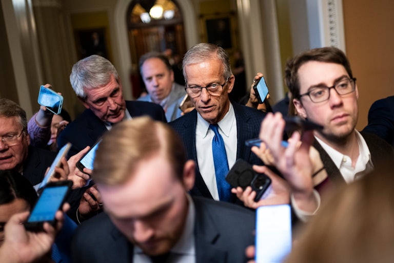Senate Majority Leader John Thune speaks to reporters while walking in the Capitol
