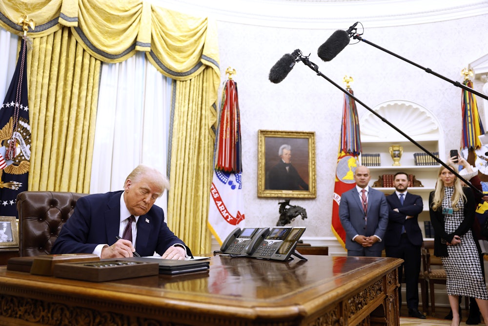 President Donald Trump signs a series of executive orders in the Oval Office of the White House on January 23, 2025, including clemency for anti-abortion activists.