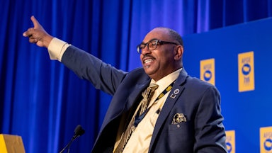 AFGE president Everett Kelley photographed behind a podium during a speech.