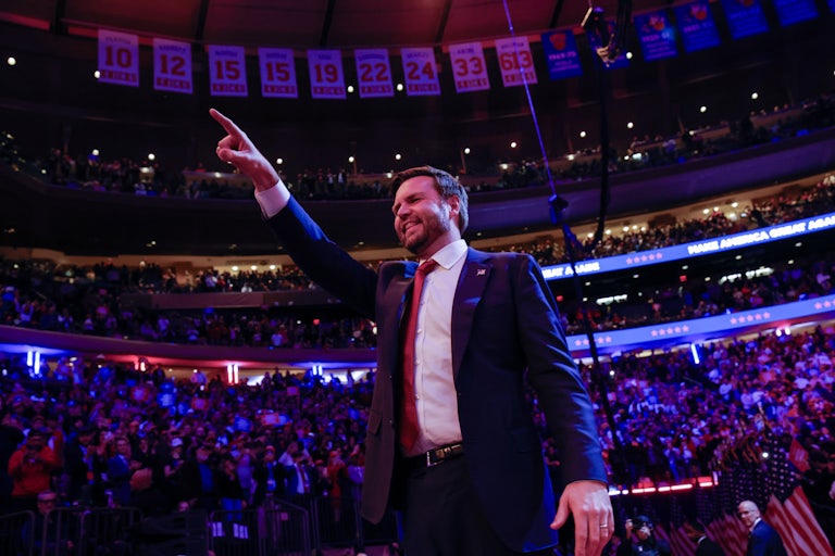 JD Vance smiles and points at the crowd during a Donald Trump rally