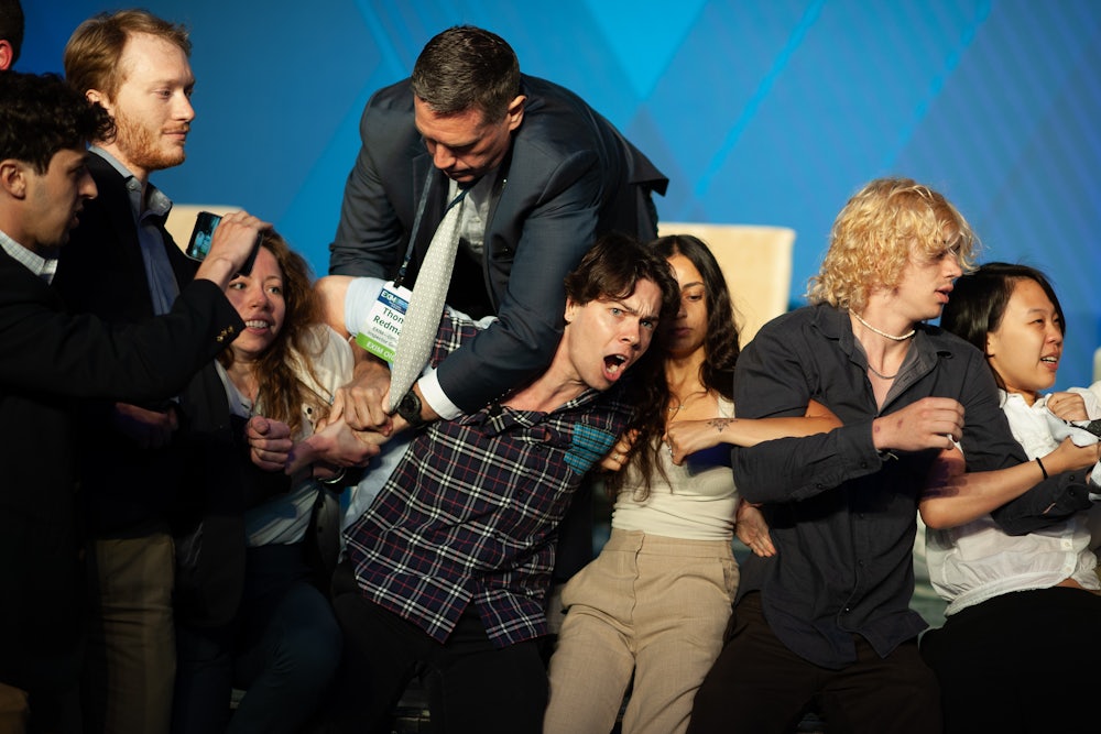 Activists struggle with people in suits.