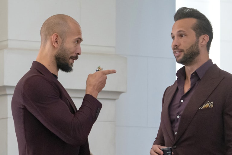 Andrew Tate points at his brother Tristan Tate as they speak while standing in the Court of Appeals in Bucharest, Romania