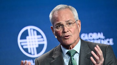 Darren Woods gestures while speaking.