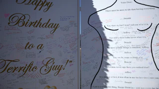 Epstein birthday card protest art – other people have scribbled messages over it