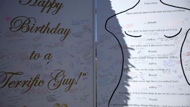 Epstein birthday card protest art – other people have scribbled messages over it