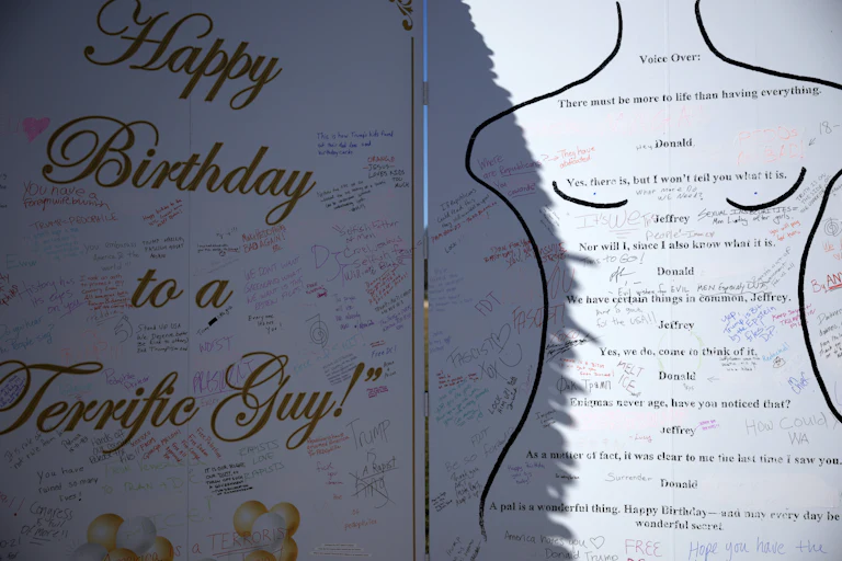 A piece of Epstein birthday card protest art, on which other people have scribbled messages.