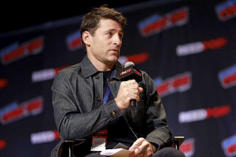 News anchor Tony Dokoupil speaks into a microphone while sitting in a chair