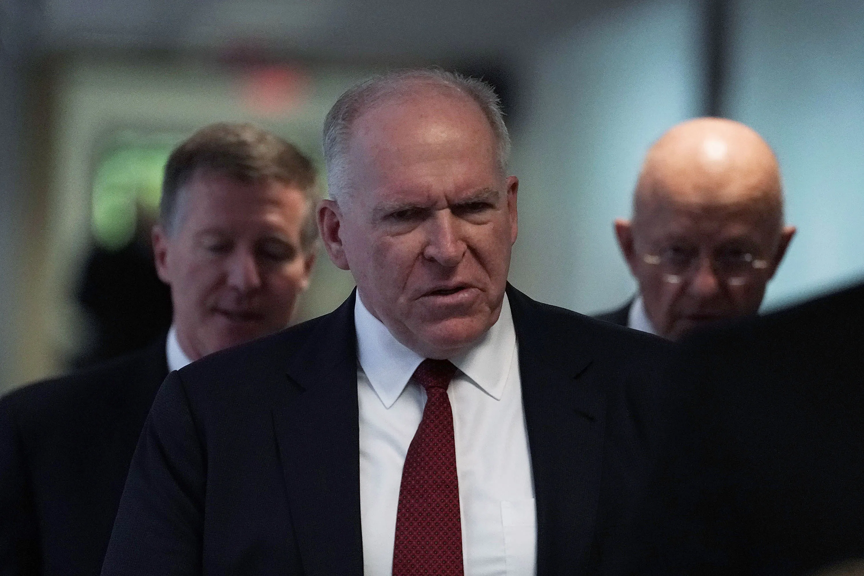Former CIA Director John Brennan walks
