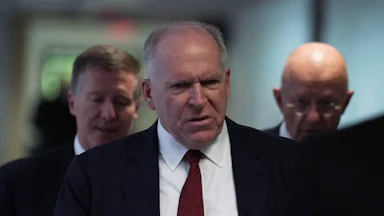 Former CIA Director John Brennan walks