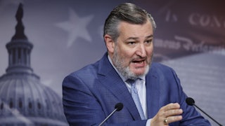 Ted Cruz at a lectern speaks and gestures as if he is angry about something.