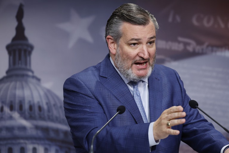 Ted Cruz at a lectern speaks and gestures as if he is angry about something.