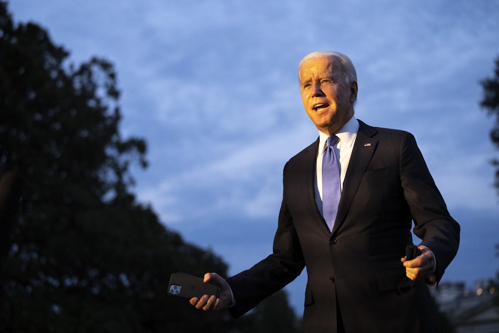 President Joe Biden enthusiastically gesticulates to a crowd.