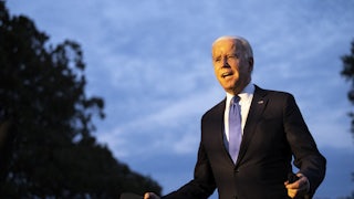 President Joe Biden enthusiastically gesticulates to a crowd.