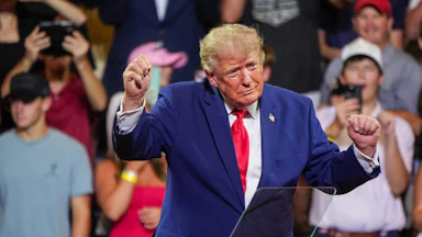 Donald Trump dances on stage during an event
