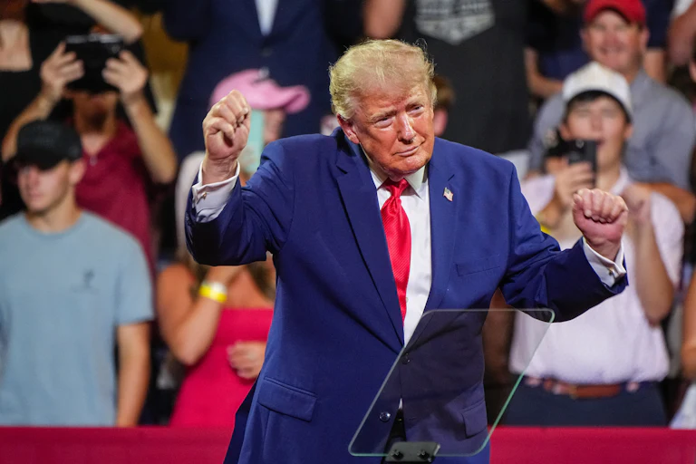 Donald Trump dances on stage during an event
