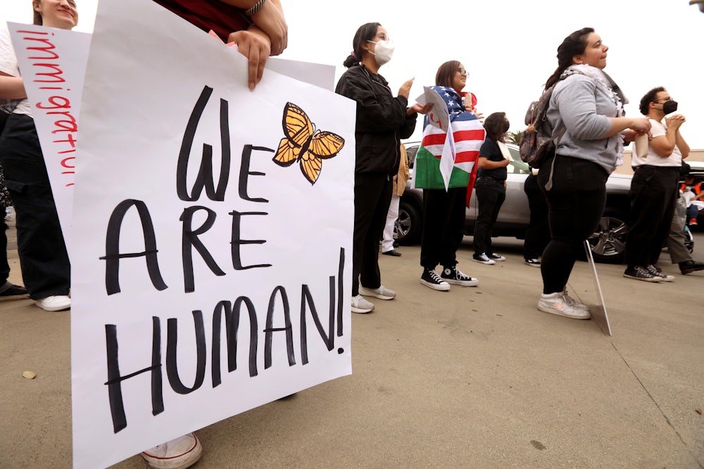 Dozens of protesters participate in a "mass demonstration against mass deportation" in Ontario, California.