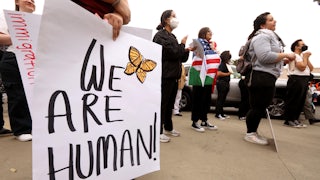 Dozens of protesters participate in a "mass demonstration against mass deportation" in Ontario, California.