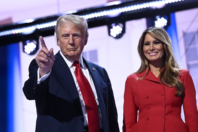 Donald Trump points while standing next to Melania Trump onstage at the Republican National Convention