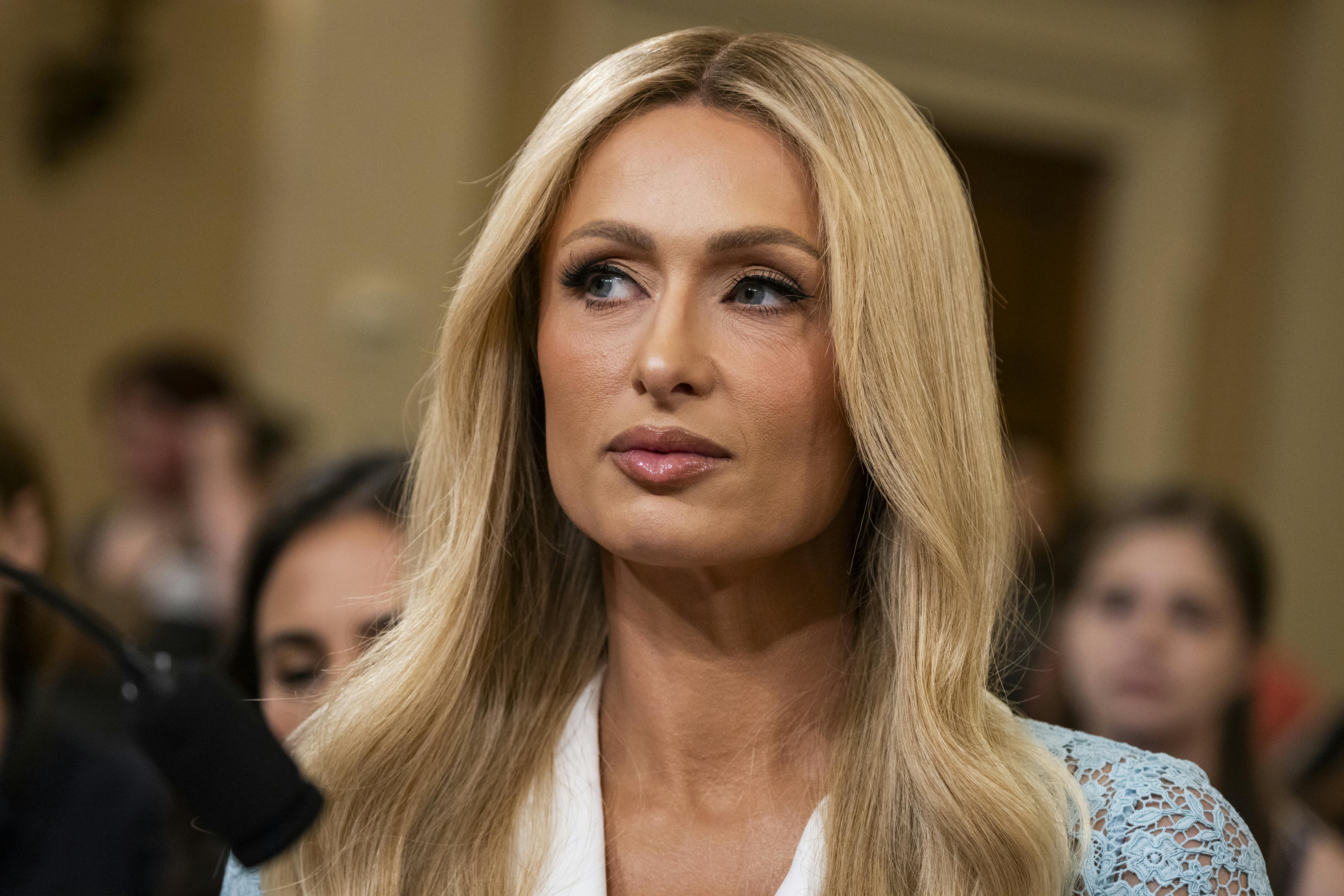 Paris Hilton sits in a House hearing