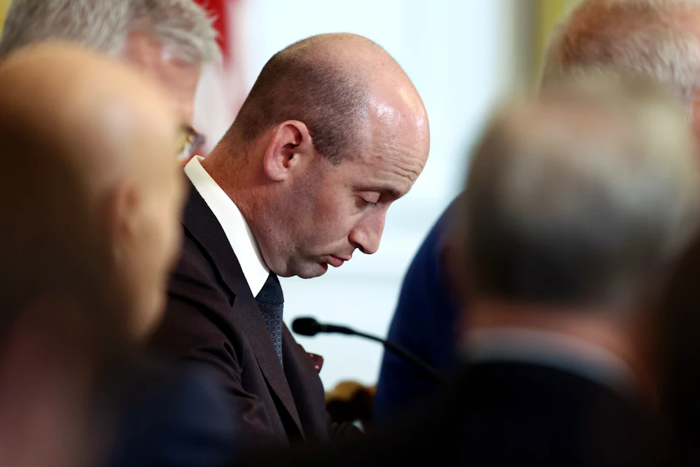 Stephen Miller stares downward