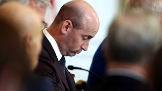 Stephen Miller stares downward