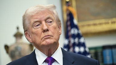 Donald Trump stands during a press conference