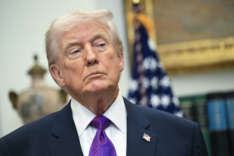 Donald Trump stands during a press conference