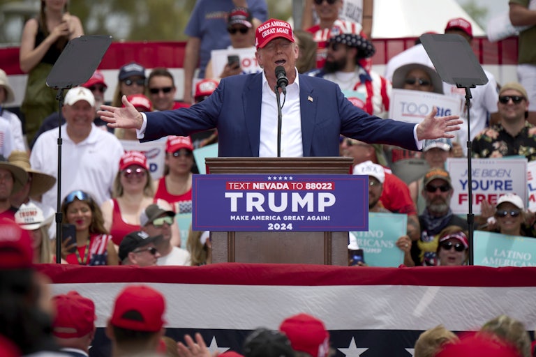 Donald Trump gestures as he speaks at a podium