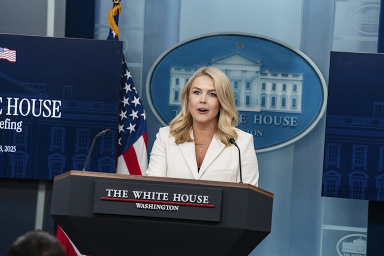 White House Press Secretary Karoline Leavitt speaks at a podium during a briefing