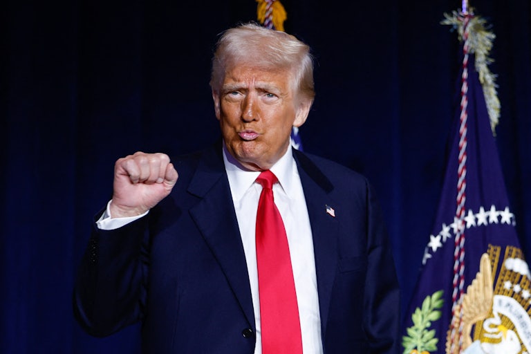 Donald Trump pumps his fist and purses his lips