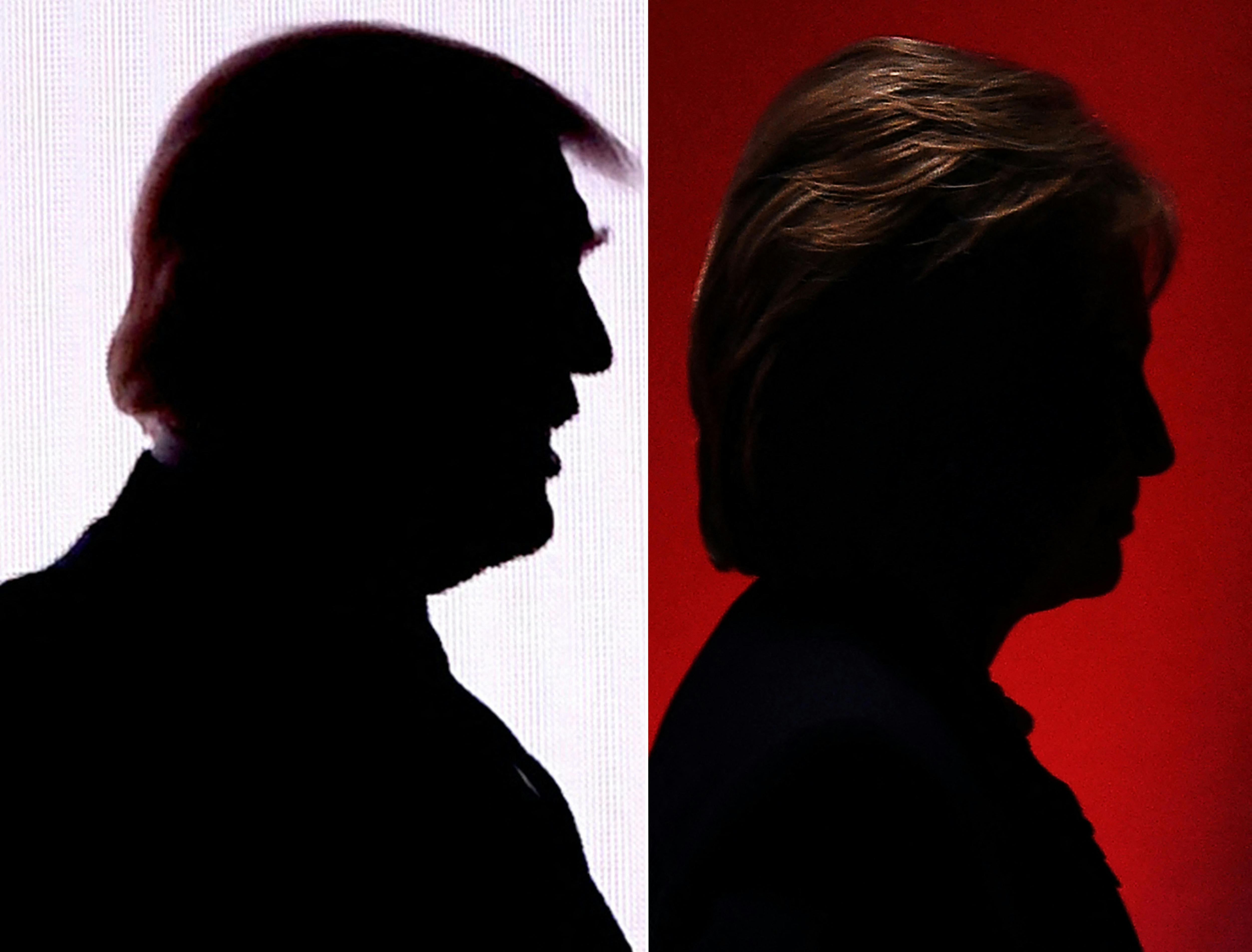 Silhouettes of Donald Trump and Hillary Clinton are seen side by side.