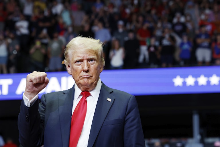 Donald Trump raises his fist during a campaign event