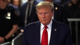 Donald Trump walking, police in the background