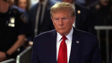 Donald Trump walking, police in the background