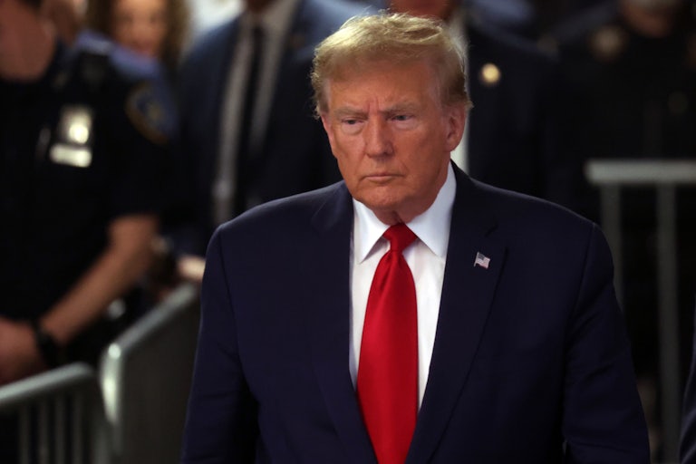 Donald Trump walking, police in the background