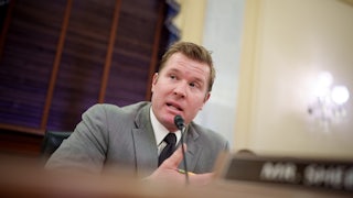 Senator Tim Sheehy speaks into a microphone during a Senate committee hearing