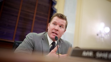 Senator Tim Sheehy speaks into a microphone during a Senate committee hearing