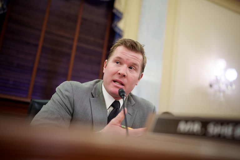 Senator Tim Sheehy speaks into a microphone during a Senate committee hearing